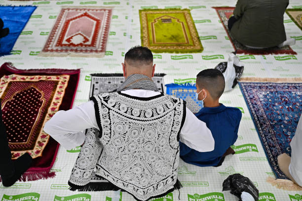 GLASGOW, SCOTLAND - MAY 13: Muslim’s perform an Eid Al-Fitr prayer at the Islamic Centre Scotstoun on May 13, 2021 in Glasgow, Scotland. Eid al-Fitr marks the end of Ramadan, which is celebrated with prayers, family reunions and other festivities among Muslims communities worldwide. (Photo by Jeff J Mitchell/Getty Images)